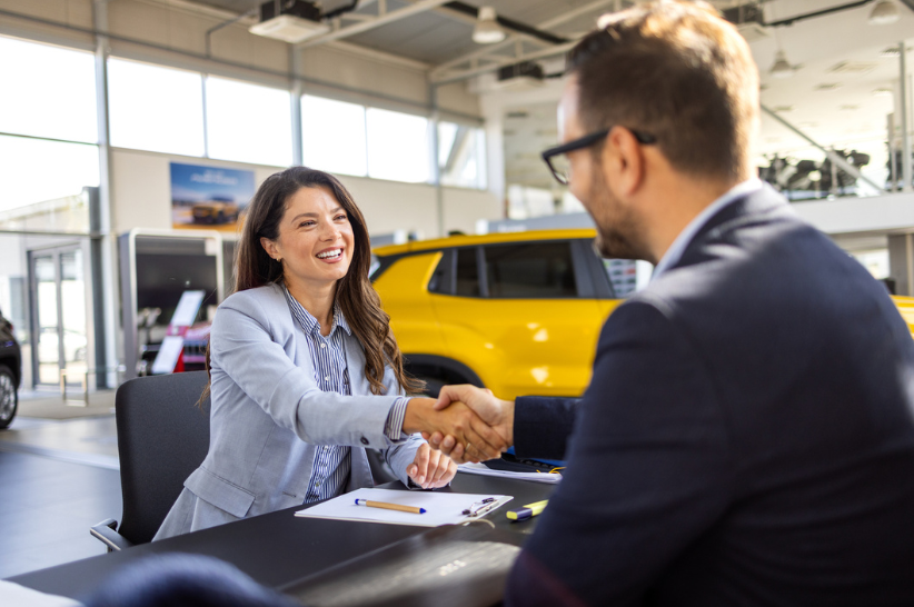 woman sitting down shaking a mans hand